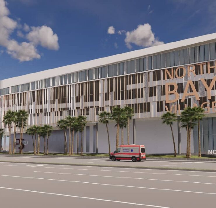 Rendering of the proposed North Bay Village municipal complex, featuring a modern façade, palm trees, and emergency vehicles.